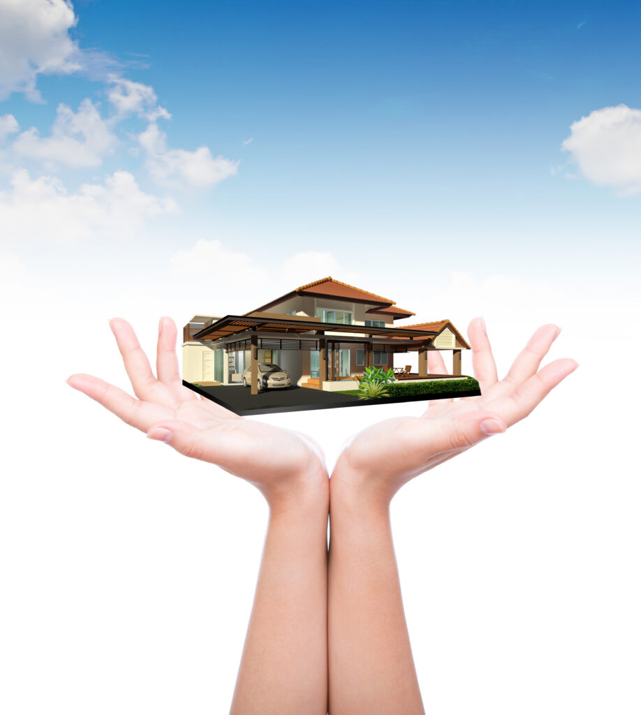 House in human hand over blue sky